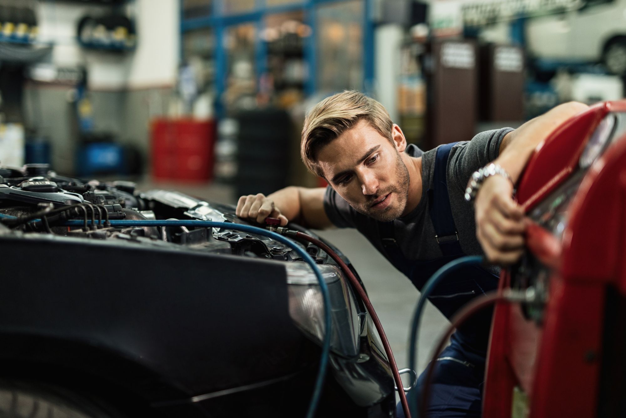 Mechanic performing routine general car service including oil change and safety check at Bueno Garage in Everton Hills