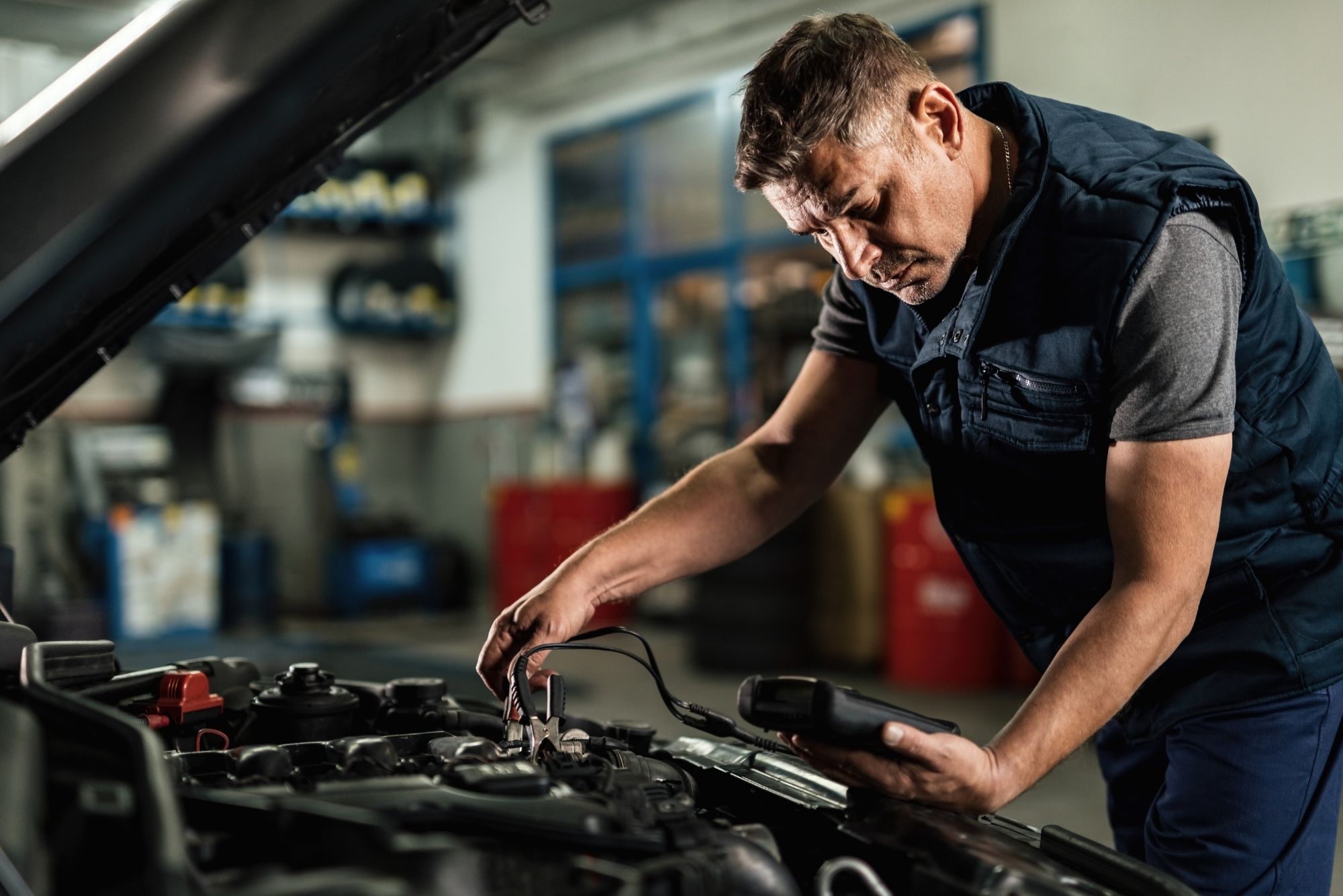 Mechanic performing logbook service on a late-model vehicle at Bueno Garage in Everton Hills, Brisban