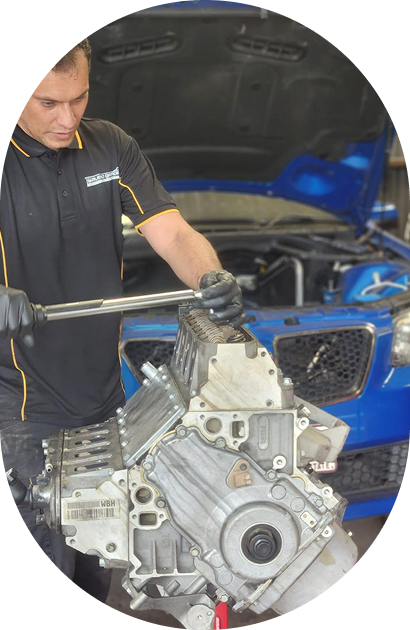 Experienced local mechanic working on a vehicle inside Bueno Garage workshop in Everton Hills, Brisbane