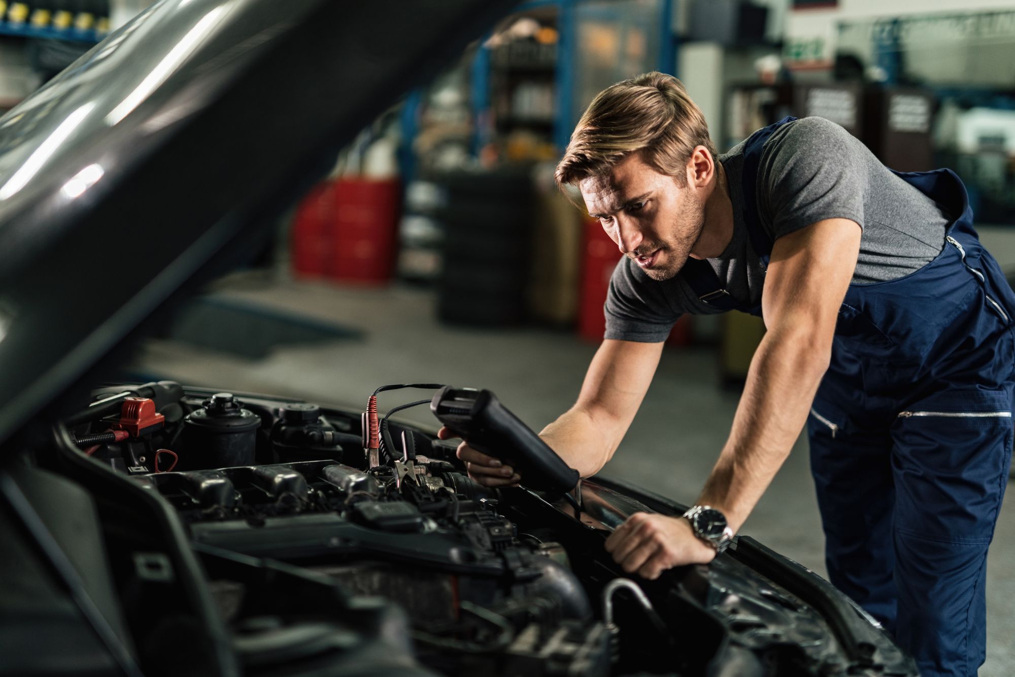 Mechanic conducting roadworthy inspection on a vehicle with official RWC checklist at Bueno Garage in Everton Hills